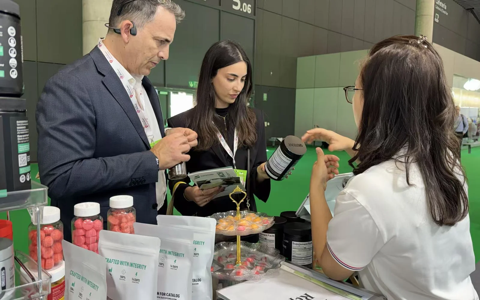 Visitors discussing gummy products with a SUCOTOND representative at an exhibition