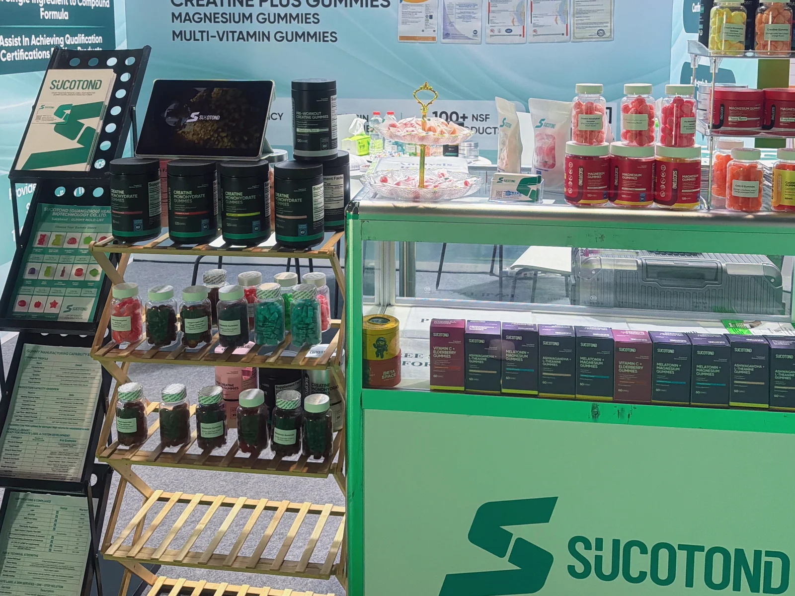 Jars of colorful gummy samples and packaged products arranged on display shelves