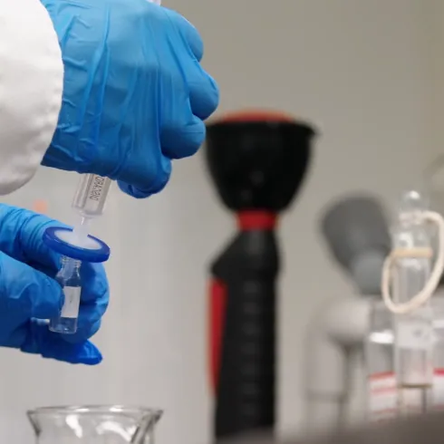 Laboratory technician preparing a sample for finished apple cider vinegar gummy acid testing
