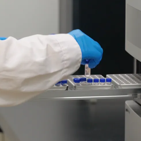 A laboratory technician loads sample vials into analytical equipment to generate quality data for ashwagandha gummies, supporting process documentation and market regulatory assessments.