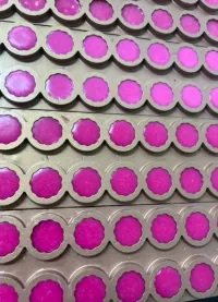 Purple ashwagandha collagen gummy mixture setting in round molds for a women’s wellness product concept positioned around mood and skin support.
