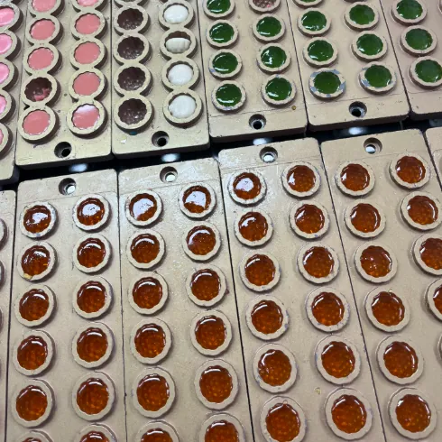 Different gummy shapes and colors in production molds for piece format review