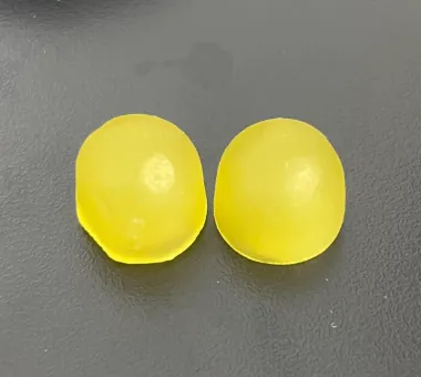 Two yellow round gummy samples displayed alone on a dark surface for a 2:1:1 BCAA product concept