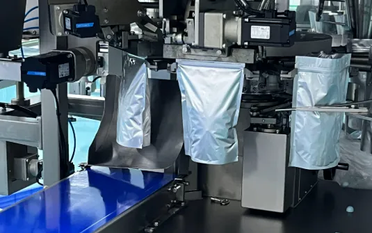 Silver pouches attached to a production packaging machine for a custom gummy project