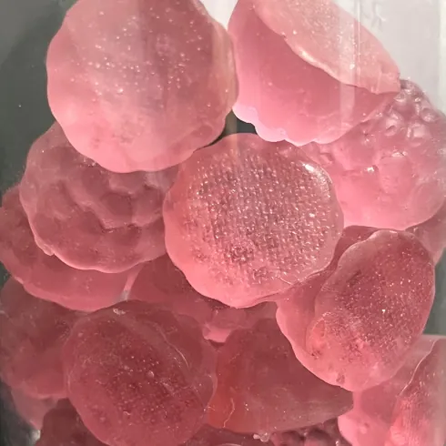 Close-up of translucent red-purple gummy samples used as a beetroot color reference