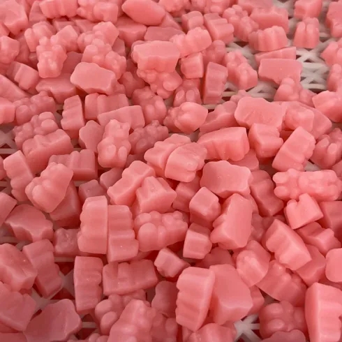 Pink cube-shaped gummy samples on a tray for beetroot gummy texture and sensory review