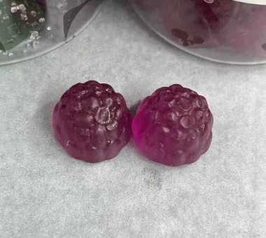 Two purple berry-shaped gummy samples for a High-Strength Beetroot Gummies concept