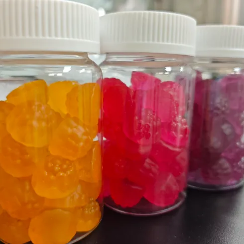 Bottled purple biotin gummies on a packaging line, representing packaging and market-documentation support beyond private label biotin gummy manufacturing.