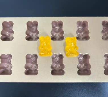 Yellow and purple gummy bear samples for a standard 3 g, 2500 mcg biotin gummies formula, available for white label supply or custom combination development.