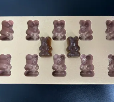 Dark biotin and iron gummy samples formulated with ferrous bisglycinate to reduce metallic taste, optimize texture and support an energy-focused combination product.