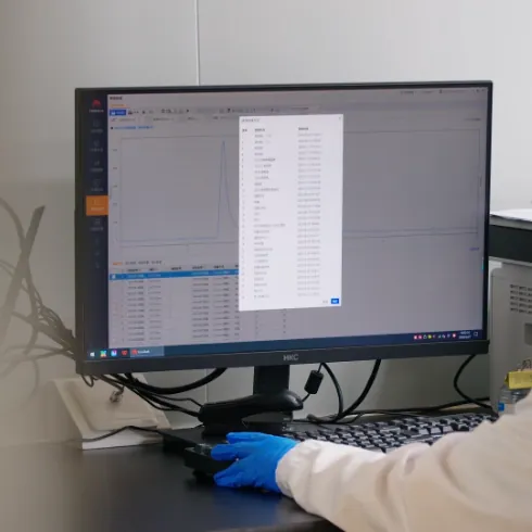 Quality technician reviewing digital test data at a computer, supporting Creatine D3 K2 Gummies regulatory assessment, production records and product delivery documentation.