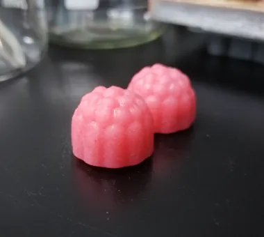 Two pink berry-shaped Creatine D3 K2 Gummies formulated per serving with 4 g creatine monohydrate, 5,000 IU vitamin D3 and 100 mcg vitamin K2 for a women’s healthy aging product concept.