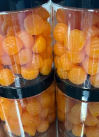 Bottles of orange berry-shaped D3 K2 Creatine Gummies for runners, a higher-creatine product concept using microencapsulated vitamin ingredients for endurance-support positioning.