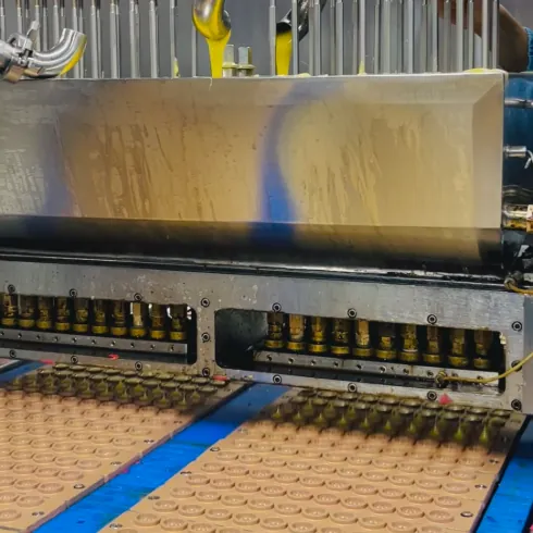 Gummy depositing equipment fills molds during high-load creatine electrolyte gummy production