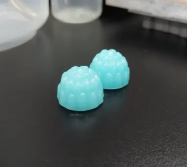 Two blue Creatine Electrolyte Gummies formulated with potassium, sodium and zinc gluconates for women's daily post-workout electrolyte product positioning.