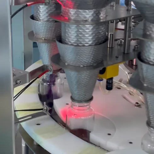 Automated production equipment handling finished bottles during elderberry gummy manufacturing