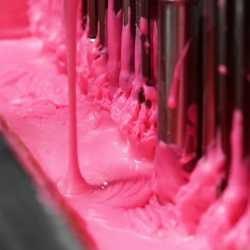 Gummy mass moving through depositing equipment during controlled elderberry gummy processing