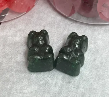 Dark bear-shaped gummy samples for vegan pectin elderberry gummy development