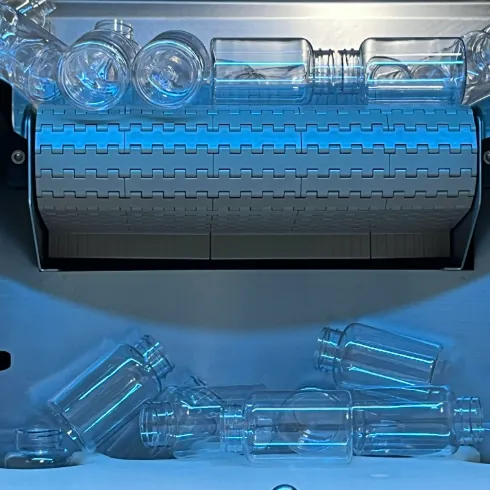 Clear packaging bottles on a gummy production line