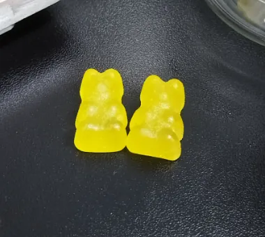 Yellow bear-shaped iron and vitamin C gummies for custom supplement formulations