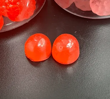 Two red round magnesium citrate gummies representing an accessible private label magnesium gummies option with good solubility and moderate cost for brands entering the market.