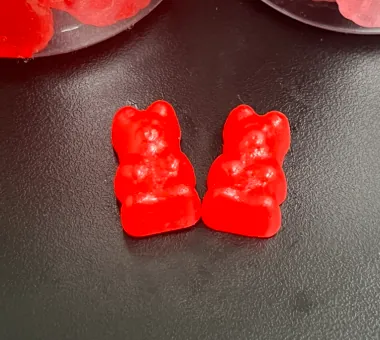Two red bear-shaped magnesium glycinate gummies made with magnesium bisglycinate, a premium private label option positioned for gentle, easy-to-absorb mineral supplementation.