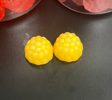 Two yellow berry-shaped triple magnesium complex gummies combining magnesium citrate, magnesium glycinate and magnesium L-threonate for a differentiated private label product.