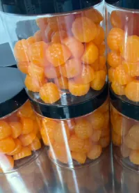Jars of orange magnesium gummies for adults, prepared for private label relaxation-focused product projects and adult mineral supplement lines.