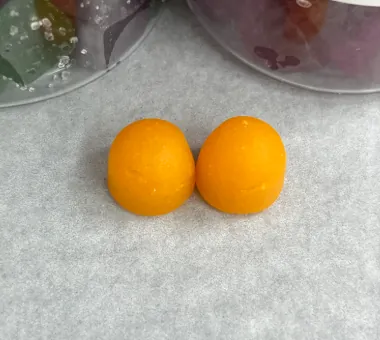Orange prebiotic and probiotic gummy samples combining probiotic strains with inulin or FOS as fermentation substrates for a premium gut-health product concept.