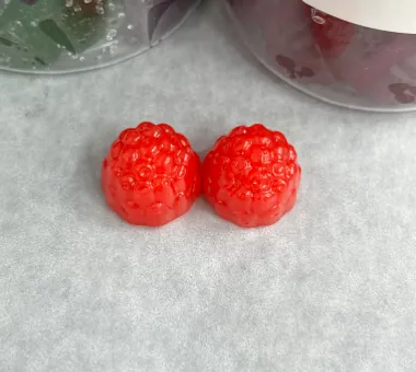 Red triple-action probiotic gummy samples combining prebiotic, probiotic and postbiotic components in one custom formula for comprehensive product positioning.