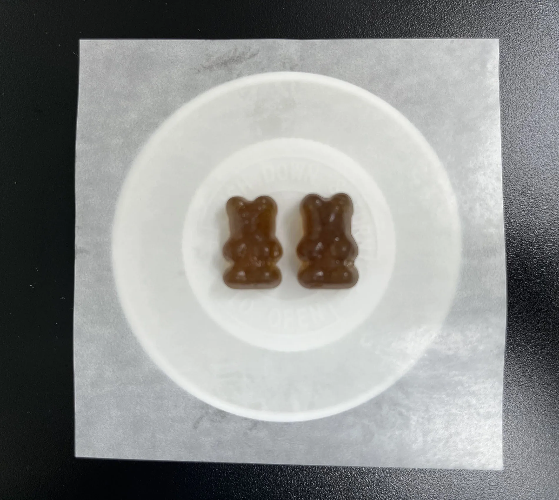 Brown high protein gummy bear samples made with a pectin and cellulose gel system that supports protein ingredient loading up to 40% per gummy for high-protein product positioning.