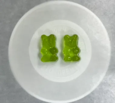 Green whey protein gummy bear samples made with whey protein raw material containing 92% protein, supporting a complete-protein product story and custom sourcing options.