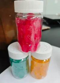 Three jars of colorful gummy samples for a kids protein gummies project combining protein with vitamins D3 and K2 in a 3 g-per-gummy format for children's nutrition product development.