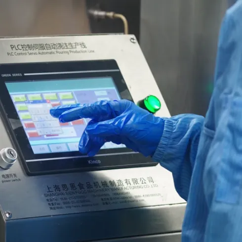 Operator reviewing controlled production settings during sea moss gummy quality screening