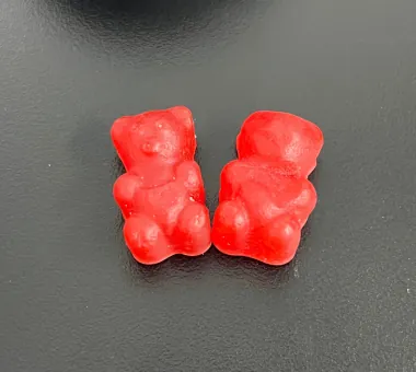 Two red bear-shaped gummy samples displayed for the 4000 mg Shilajit Gummies product category