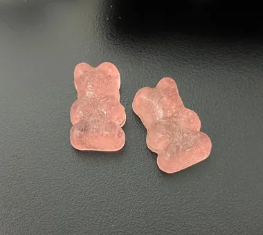 Two peach-colored bear-shaped gummy samples displayed for the Shilajit Gummies for Women product concept