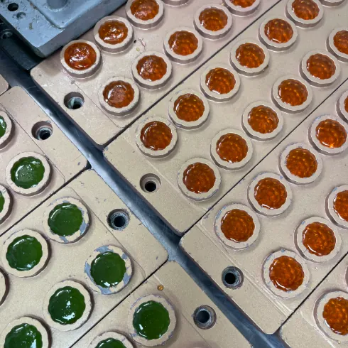 Green and orange gummy mold samples for separate botanical and fiber formulation review