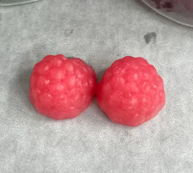 Two red berry-shaped gummy samples for a fruit and vegetable gummy product concept