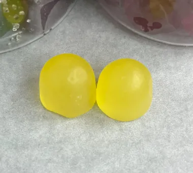 Two smooth yellow gummy samples for a superfood multivitamin gummy concept
