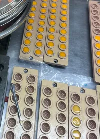 Golden and amber gummy samples compared during a turmeric supplier color-shift evaluation