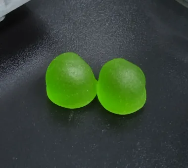 Green dual-form vitamin B12 gummies used to represent a methylcobalamin and adenosylcobalamin concept