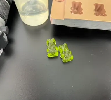 Two green bear-shaped Vitamin D3 K2 gummies representing a standard 5000 IU plus 100 mcg formula, with encapsulation available for bone-support and calcium-product positioning.