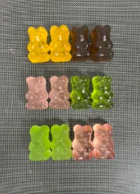 Rows of multicolored bear-shaped kids vitamin gummies representing custom formulas with vitamins A, C, D and E, plus vitamin-and-mineral and Vitamin D3 K2 project options.